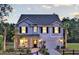 Charming two-story home with palm trees and a well-manicured lawn on a sunny day at 121 Royal Cainhoy Way, Huger, SC 29450