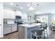 Modern kitchen with stainless steel appliances, marble countertops, and a breakfast bar at 121 Royal Cainhoy Way, Huger, SC 29450