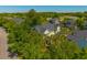 Aerial view highlights a green home surrounded by lush trees in a serene neighborhood at 1225 Blakeway St # 1401, Charleston, SC 29492