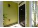 Close-up of a stylish black front door with a decorative light fixture and unit number at 1225 Blakeway St # 1401, Charleston, SC 29492