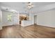 Open concept living area with adjacent kitchen, ceiling fan, and natural light streaming through a door at 1225 Blakeway St # 1401, Charleston, SC 29492