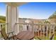 Outdoor balcony with outdoor seating and table overlooking community landscaping and amenities at 1300 Park West Blvd # 215, Mount Pleasant, SC 29466
