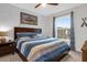 Nicely decorated bedroom with ceiling fan, plush bed, and large window bringing in natural light at 1300 Park West Blvd # 215, Mount Pleasant, SC 29466