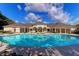 Inviting community pool with lounge chairs and a charming clubhouse backdrop on a bright day at 1300 Park West Blvd # 215, Mount Pleasant, SC 29466
