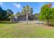 Outdoor tennis courts with palm trees and a well-maintained green space and fence at 1300 Park West Blvd # 215, Mount Pleasant, SC 29466