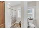 Bright bathroom features a shower with decorative curtain, toilet, and natural light from windows at 1305 Old Rice Mill Rd, Moncks Corner, SC 29461