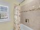 Bathroom with a tiled shower and tub combo and floral shower curtain at 1305 Old Rice Mill Rd, Moncks Corner, SC 29461