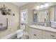 Well-lit bathroom with granite countertop vanity, a toilet and decorative mirror at 1305 Old Rice Mill Rd, Moncks Corner, SC 29461