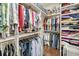 Walk-in closet with custom shelving and hanging racks for organized storage at 1305 Old Rice Mill Rd, Moncks Corner, SC 29461