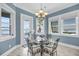 Cozy dining area with water views and an elegant chandelier and room for seating up to four at 1305 Old Rice Mill Rd, Moncks Corner, SC 29461