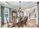 Formal dining room boasting a decorative chandelier, wainscoting, and hardwood floors leading to the staircase at 1305 Old Rice Mill Rd, Moncks Corner, SC 29461
