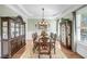 Elegant dining room featuring a chandelier, wooden table, and matching hutch with refined crown molding at 1305 Old Rice Mill Rd, Moncks Corner, SC 29461