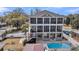 Expansive home featuring a screened porch, a swimming pool, and a spacious backyard, perfect for outdoor living and entertaining at 1305 Old Rice Mill Rd, Moncks Corner, SC 29461