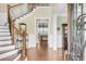 Beautiful foyer with hardwood floors, an elegant staircase, and a glimpse into the living room, showcasing a seamless flow at 1305 Old Rice Mill Rd, Moncks Corner, SC 29461