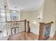 Spacious home foyer featuring hardwood floors, chandelier and a staircase with decorative ironwork at 1305 Old Rice Mill Rd, Moncks Corner, SC 29461
