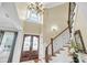 Elegant foyer featuring a grand staircase, soaring ceilings, and decorative lighting, creating a welcoming entrance at 1305 Old Rice Mill Rd, Moncks Corner, SC 29461