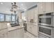 Chef's kitchen features stainless appliances, granite countertops, custom cabinetry, and island cooktop at 1305 Old Rice Mill Rd, Moncks Corner, SC 29461