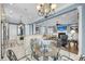 Open kitchen and living area showcasing white cabinets, granite counters, stainless appliances, and stylish light fixtures at 1305 Old Rice Mill Rd, Moncks Corner, SC 29461