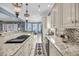 Gourmet kitchen boasts granite counters, stainless appliances, custom cabinets, and seamless flow to dining area at 1305 Old Rice Mill Rd, Moncks Corner, SC 29461