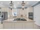 Bright, modern kitchen with stainless steel appliances, an island cooktop, and granite countertops at 1305 Old Rice Mill Rd, Moncks Corner, SC 29461