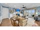 Comfortable living room with blue walls, fireplace, ceiling fan, and water views through french doors at 1305 Old Rice Mill Rd, Moncks Corner, SC 29461
