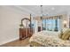 Bedroom featuring a four-poster bed, chandelier, water views, and access to a private balcony at 1305 Old Rice Mill Rd, Moncks Corner, SC 29461