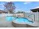Inviting outdoor pool and spa with a white fence surround, set against a clear blue sky at 1305 Old Rice Mill Rd, Moncks Corner, SC 29461