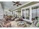 Large screened porch offers multiple seating areas and stunning waterfront views with overhead ceiling fans at 1305 Old Rice Mill Rd, Moncks Corner, SC 29461
