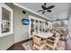Inviting screened porch with ceiling fans, comfortable seating, and outdoor dining area for relaxation at 1305 Old Rice Mill Rd, Moncks Corner, SC 29461
