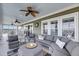 Open sunroom features comfortable seating, ceiling fan, and views of the water at 1305 Old Rice Mill Rd, Moncks Corner, SC 29461