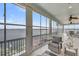 Comfortable sunroom with water views, ceiling fan and seating, a great spot to unwind at 1305 Old Rice Mill Rd, Moncks Corner, SC 29461