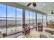 Bright sunroom with floor to ceiling windows and cozy wicker furniture at 1305 Old Rice Mill Rd, Moncks Corner, SC 29461