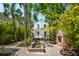 Charming backyard featuring a water feature, brick fireplace, mature trees, and well-manicured landscaping at 135 Beaufain St, Charleston, SC 29401