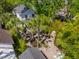 Aerial view of the backyard featuring a brick fireplace and water feature nestled in lush greenery at 135 Beaufain St, Charleston, SC 29401