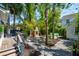 Lush backyard featuring a brick fireplace, seating area, and serene water feature, perfect for outdoor entertaining at 135 Beaufain St, Charleston, SC 29401