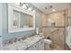 Elegant bathroom featuring double sinks with granite countertops, a frameless glass shower, and modern fixtures at 135 Beaufain St, Charleston, SC 29401