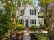 Charming home with black shutters, a brick walkway, and manicured landscaping enhancing its curb appeal at 135 Beaufain St, Charleston, SC 29401