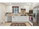 Modern kitchen features stainless steel appliances, white cabinets, granite countertops, and a stylish backsplash at 135 Beaufain St, Charleston, SC 29401