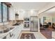 Bright kitchen boasts stainless steel appliances, white cabinets, and stylish tile flooring at 135 Beaufain St, Charleston, SC 29401