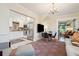 Open-concept living room seamlessly connecting to a modern kitchen with stainless steel appliances and white cabinetry at 135 Beaufain St, Charleston, SC 29401