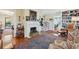 Inviting living room features a fireplace, hardwood floors, and a colorful rug leading to the staircase and other rooms at 135 Beaufain St, Charleston, SC 29401