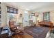 Cozy living room with hardwood floors, a decorative rug, large windows, and comfortable seating arrangements at 135 Beaufain St, Charleston, SC 29401