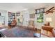 Comfortable living room with hardwood floors, a decorative rug, large windows, and built in bookshelves at 135 Beaufain St, Charleston, SC 29401