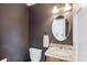 Stylish powder room featuring a modern vanity, granite countertop, and elegant fixtures at 135 Beaufain St, Charleston, SC 29401