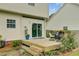 Cozy back deck with seating, accessible by sliding glass door, complemented by lush landscaping at 137 Cotillion Cres, Summerville, SC 29483