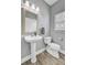 Clean bathroom featuring a pedestal sink, toilet, and a stylishly framed mirror at 137 Cotillion Cres, Summerville, SC 29483