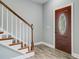Welcoming entryway showcases wood-look floors, a staircase with wooden banister, and elegant front door at 137 Cotillion Cres, Summerville, SC 29483