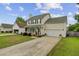 Inviting 2-story house with green shutters, 2-car garage, and well-maintained lawn provides a welcoming appeal at 137 Cotillion Cres, Summerville, SC 29483