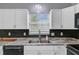 Bright and spacious kitchen with stainless steel sink, white cabinets and accent tile backsplash at 137 Cotillion Cres, Summerville, SC 29483