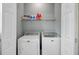 Bright laundry room featuring a Maytag washer and dryer with a storage shelf above for supplies at 137 Cotillion Cres, Summerville, SC 29483